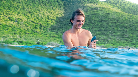 Rider in the water beside a Waydoo Flyer EVO eFoil mast and motor