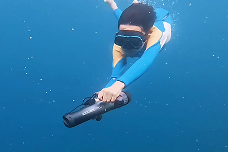 Freediver underwater holding a Waydoo Subnado Plus underwater scooter