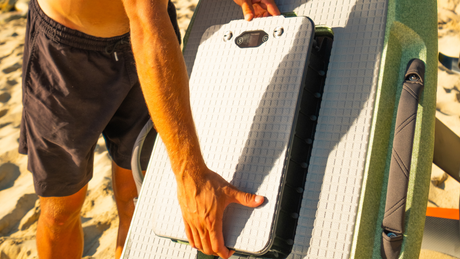 Aerial view of a rider flying a Waydoo eFoil electric hydrofoil over clear water