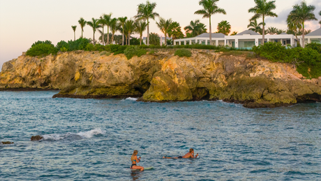 eFoil riders resting on their boards in a calm bay between flights